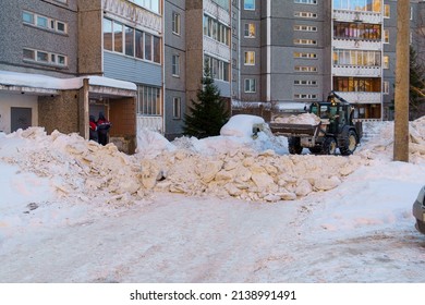 Petrozavodsk, Russia, 03.01.2022 Tractor Of Medium Size Removes Snow In City Yard In Winter