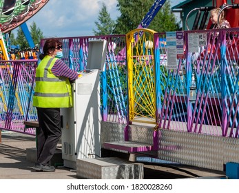 Petrozavodsk, Russia - 1 August 2020. Amusement Park Worker In Face Protective Mask