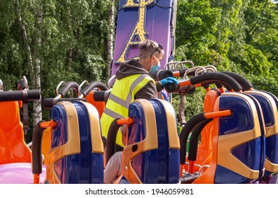 Petrozavodsk, Russia - 1 August 2020. Worker Of The Amusement Park In A Medical Mask At Work
