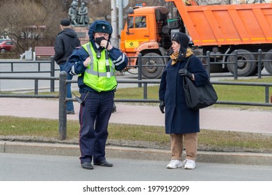 Petrozavodsk, Russia - 1 May 2021. Traffic Police Officer Talks To Elderly Woman