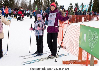 PETROZAVODSK,RUSSIA-FEBRUARY 9TH,2019: Mom And Daughter Are Skiing To Attend A Sporting Event