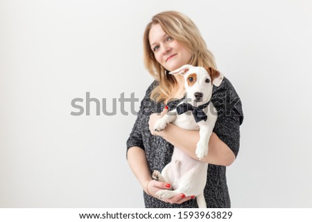 Pets and animal concept - Pretty woman with puppy Jack Russell Terrier on white background with copyspace