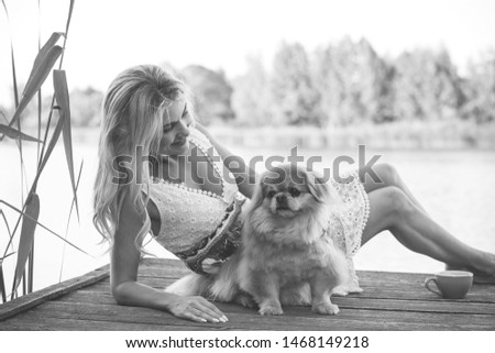 Pets concept. Nice girl with a golden at nature, enjoy the life