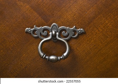 Pewter Silver Metal Handle Or Knocker On Dark Rich Mahogany Wood Dresser Door.