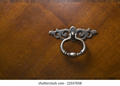 Pewter Silver Metal Handle Or Knocker On Dark Rich Mahogany Wood Dresser Door.