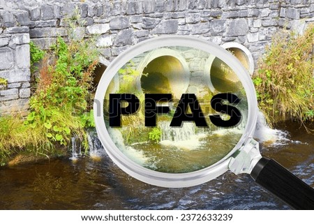 PFAS Contamination - Alertness about dangerous PFAS per-and polyfluoroalkyl substances presence in polluted urban wastewater - Concept with magnifying glass