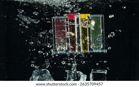 PH acid level test kit on quality water on screen. PH acid level tester kit tools fall under water splashing splattering with air bubble over black background isolated