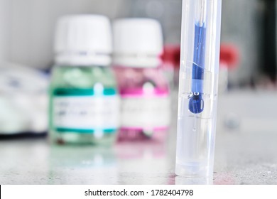 PH Meter With Glass Electrode For Measuring Of Alkalinity And Acidity With Calibration Solution On The Background. Analytical Or Electro Chemistry Laboratory