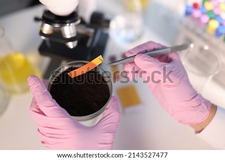 PH test strip and soil study in laboratory closeup