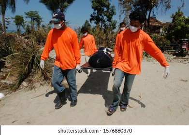 Phang Nga, Thailand - December 30, 2004 : Rescue Workers Carry A Dead Body In The Devastated Khao Lak After The Tsunami.