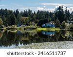 PHANTOM LAKE WITH A NICE REFLECTION IN THE WATER AND SHORELINE IN BELLEVUE WASHINGTON