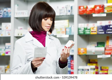 Pharmacceutist Woman Worker In Drug Store