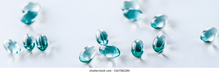 Pharmaceutical, branding and science concept - Blue pills for healthy diet nutrition, supplements pill and probiotics capsules, healthcare and medicine as pharmacy and scientific research background - Shutterstock ID 1567382284