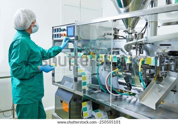 pharmaceutical factory woman worker\
operating production line at pharmacy industry manufacture\
factory