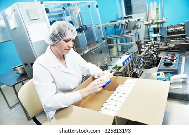 pharmaceutical factory worker at pharmacy industry manufacture packing medicine into boxes