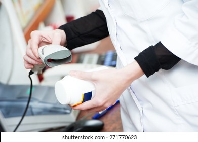 pharmaceutical female worker scanning barcode of medicine drug in a pharmacy drugstore  - Powered by Shutterstock