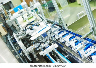 pharmaceutical industry. Line machine conveyer for packaging glass bottles ampoules in boxes at pharmacy factory