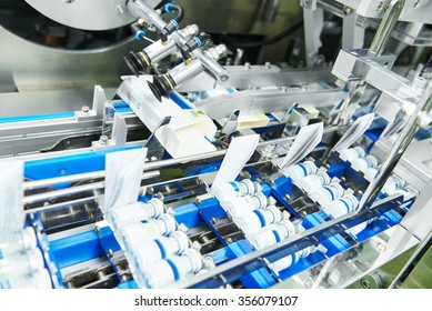 Pharmaceutical Industry. Line Machine Conveyer For Packaging Glass Bottles Ampoules In Boxes At  Factory