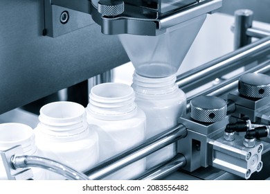 pharmaceutical industry, medicine pills are filling in the  bottle on production line machine conveyor at the medical factory. selective focus.