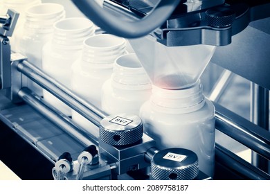 Pharmaceutical Industry, Medicine Pills Are Filling In The  Bottle On Production Line Machine Conveyor At The Medical Factory. Selective Focus.