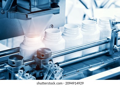 pharmaceutical industry, medicine pills are filling in the  bottle on production line machine conveyor at the medical factory. selective focus. - Shutterstock ID 2094914929