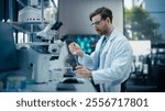 Pharmaceutical Laboratory: Young Male Scientist Working with Samples, Using Micro Pipette for Mixing Chemicals and Acids. Advanced Scientific Specialist Working with Modern Digital Microscope