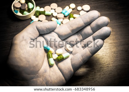Pharmaceutical medicament, cure in container for health. Pharmacy theme, Heap of green blue white round capsule pills with medicine antibiotic in packages. Drug prescription for treatment medication.