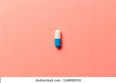 Pharmaceutical medicine pills, tablets and capsules on coral background. Top view. Flat lay. Copy space. Medicine concepts. Minimalistic abstract concept. Trendy pastel colors - Living coral