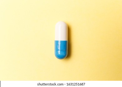 Pharmaceutical medicine pills, tablets and capsules on yellow background. Top view. Flat lay. Copy space. Medicine concepts. Minimalistic abstract concept. Antibiotics, painkillers, vitamins