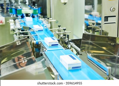 pharmaceutical packing production line conveyer at manufacture pharmacy factory. Authentic shot in challenging conditions. maybe little blurred