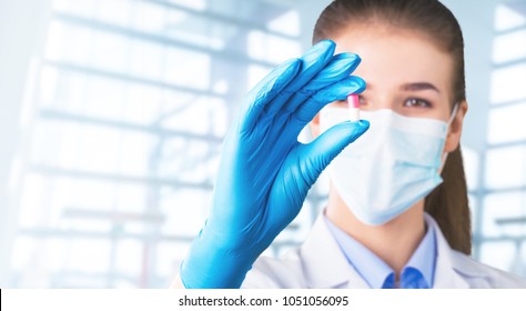 Pharmaceutical Worker Examining Pill