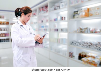 Pharmacist Chemist And Medical Doctor Woman Asia With Stethoscope And Clipboard Checking Medicine Cabinet And Pharmacy Drugstore .