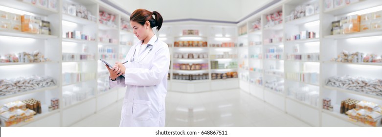 Pharmacist Chemist And Medical Doctor Woman Asia With Stethoscope And Clipboard Checking Medicine Cabinet And Pharmacy Drugstore .