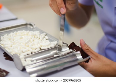 Pharmacist Counting Pills At The Pharmacy