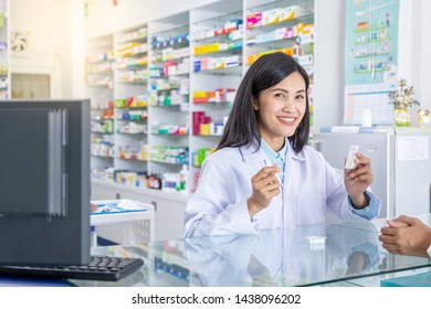 Pharmacist Explaining How To Use The Pregnancy Test Sticks To Female Customers.