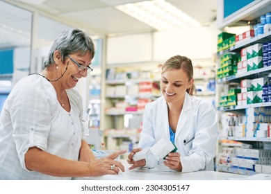 Pharmacist explaining prescription medication to woman in the pharmacy for pharmaceutical healthcare treatment. Medical, counter and female chemist talking to patient on medicine in clinic dispensary - Powered by Shutterstock