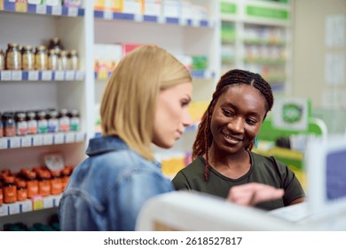 Pharmacist explaining products to a customer inside a bright, welcoming pharmacy interior.