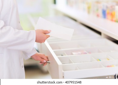 Pharmacist Filling Prescription In Pharmacy