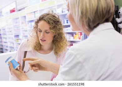 Pharmacist And Her Customer Talking About Medication In The Pharmacy