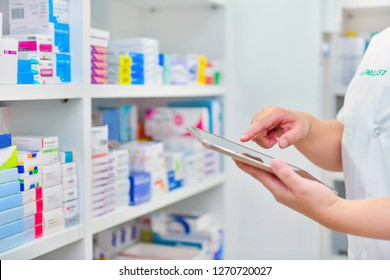 Pharmacist holding computer tablet Using for filling prescription in pharmacy drugstore. 