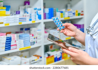 Pharmacist holding mobile phone using for filling prescription in pharmacy drugstore	 - Powered by Shutterstock