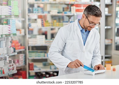 Pharmacist man, store and counting with pills, medicine and focus for health, product or sales. Medical professional, pharma expert or sorting medication in pharmacy for wellness, healthcare and job - Powered by Shutterstock