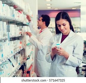 Pharmacist And Pharmacy Technician Posing In Drugstore