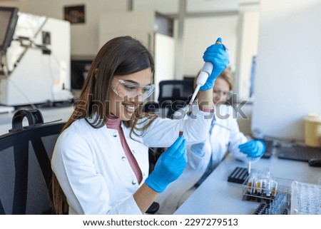 Pharmacist pipetting fluids into a bottle in the research department for the pharmaceutical industry. Scientist or researcher medical holding test tube and dropping reagent in the biochemistry lab