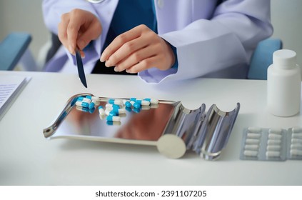 A pharmacist is preparing medicine for a patient, Pharmacists are sorting various medicines before giving them to patients. - Powered by Shutterstock