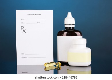 Pharmacist Prescription With Drops And Pills Isolated On Blue