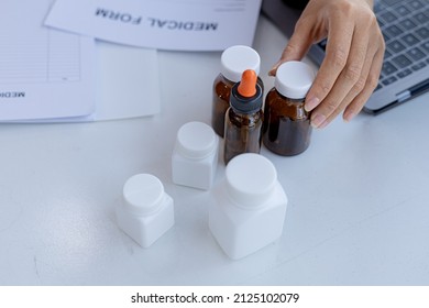 The Pharmacist Is Reviewing The List Of Drugs And Checking The Stock Of All Medicines At One Of The Pharmacies He Owns, His Home Pharmacy And Selling Medical Supplies. Pharmacy Concept.