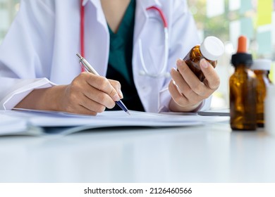 The Pharmacist Is Reviewing The List Of Drugs And Checking The Stock Of All Medicines At One Of The Pharmacies He Owns, His Home Pharmacy And Selling Medical Supplies. Pharmacy Concept.