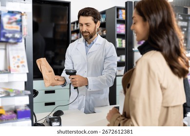Pharmacist scanning barcode of the product while female client waiting for payment