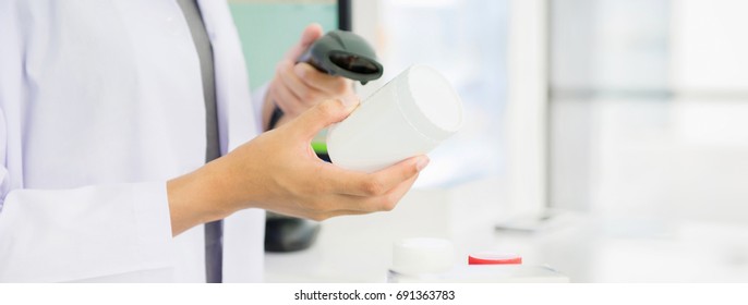 Pharmacist Scanning Medicine Bottle With Barcode Scanner In Pharmacy - Panoramic Web Banner